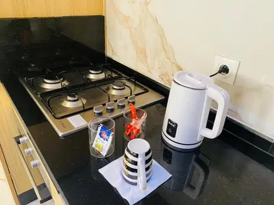 a coffee maker on a counter next to a stove at Glorious NOUACEUR in Nouaceur