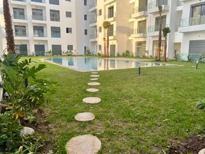 a path in the grass in front of a building at Glorious NOUACEUR in Nouaceur