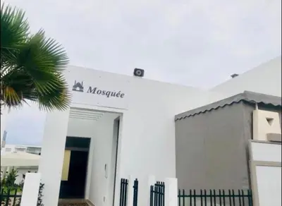 a white building with a sign that reads mixtape at Nice Apartment in Blanca Beach in Sidi Rahal