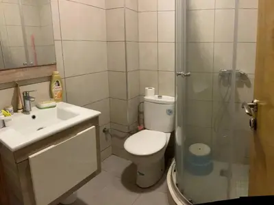 a bathroom with a toilet and a shower and a sink at Nice Apartment in Blanca Beach in Sidi Rahal