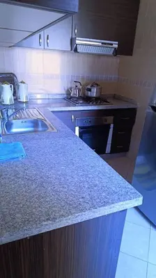 a kitchen with a counter top and a sink at appartamento in residenza protetta con piscina in Mohammedia