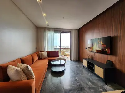 a living room with a couch and a tv at Casa finance city - Anfa Park - CFC in Casablanca
