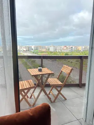 a table and chairs on a balcony with a view at Casa finance city - Anfa Park - CFC in Casablanca