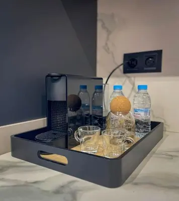 a tray of water bottles and glasses on a counter at Cozy Luxurious Bourgogne Studio in Casablanca