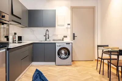 a kitchen with a washing machine in a kitchen at Cozy Luxurious Bourgogne Studio in Casablanca