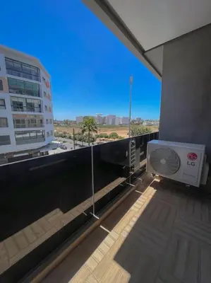 a balcony of a building with a fan on it at Cozy Luxurious Bourgogne Studio in Casablanca