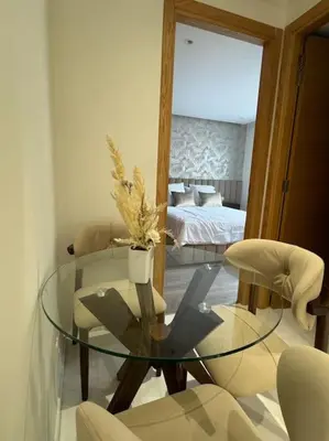 a glass table and chairs in a room with a bed at Casa Bay in Casablanca