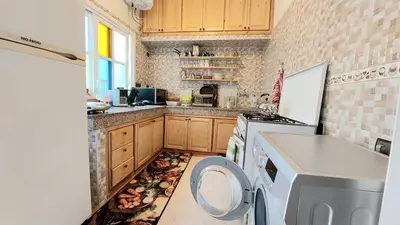a kitchen with a washer and dryer on the floor at Taddart, Maison de vacances in Temara