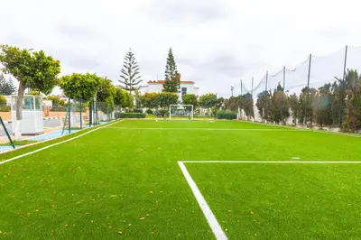 a green soccer field with a net and a goal at Villa en bord de plage, située dans une résidence à El Mansouria, idéale pour une grande famille ou pour des personnes seules in Mansouria