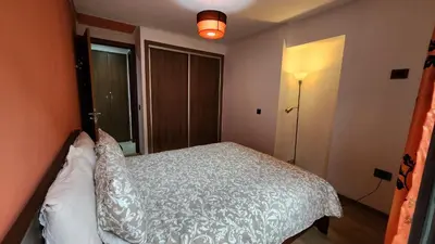 a bedroom with a white bed and a window at Sunny apartment with terrace near CasaFiananceCity in Casablanca