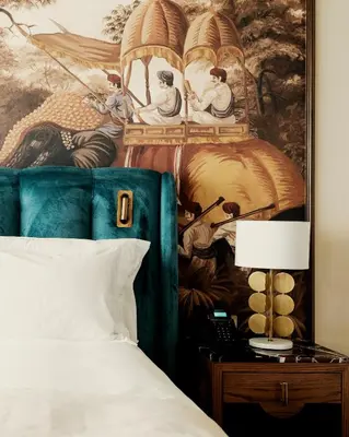 a bedroom with a painting on the wall next to a bed at Marly Boutique Hôtel in Casablanca