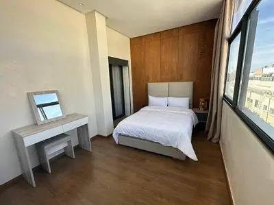a hotel room with a bed and a window at Luxurious apartment in the heart of Maarif Casa in Casablanca
