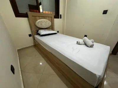a bed with two pillows on it in a room at Appartement spacieux et calme à proximité de la mer et la gare agdal in Rabat