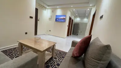 a living room with a couch and a table at Appartement spacieux et calme à proximité de la mer et la gare agdal in Rabat