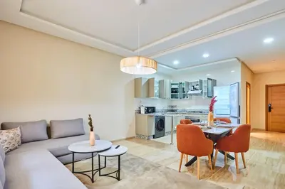 a living room with a couch and a table and chairs at City Escape Modern 1-Bed Near Casa Voyageurs in Casablanca