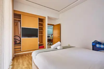 a bedroom with a large bed and a tv at City Escape Modern 1-Bed Near Casa Voyageurs in Casablanca
