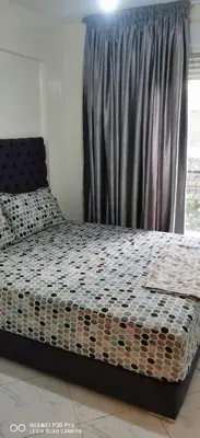 a bed sitting in a bedroom with a window at Appartement Proche plage Bouznika Bouznika in Bouznika