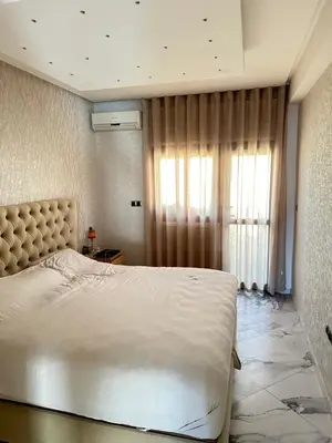 a bedroom with a large bed and a window at Chambre à Agdal Rabat dans un appartement partagé -king bed- in Rabat
