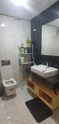 a bathroom with a sink and a toilet and a mirror at Aerostay Jamal in Dah Hammou Ben Cheïkh