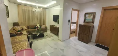 a living room with a couch and a room with a bed at Aerostay Jamal in Dah Hammou Ben Cheïkh