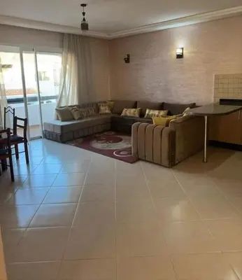 a living room with a couch and a table at Complex garden beach2 sidi rahal in Sidi Rahal