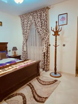 a bedroom with a bed and a large window at Luxurious Holiday Home 2 in Temara