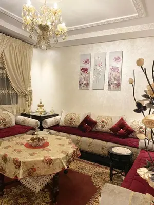 a living room with a couch and a table at Luxurious Holiday Home 2 in Temara