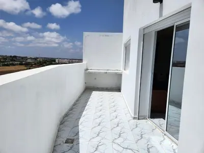 a balcony of a white building with a view at Résidence Rose Marie 24 lot 92A à côté de Harhoura in El Harhoura