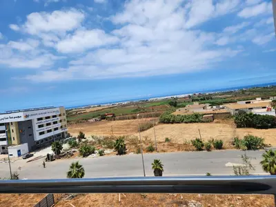 a view from a window of a street and a building at Résidence Rose Marie 24 lot 92A à côté de Harhoura in El Harhoura