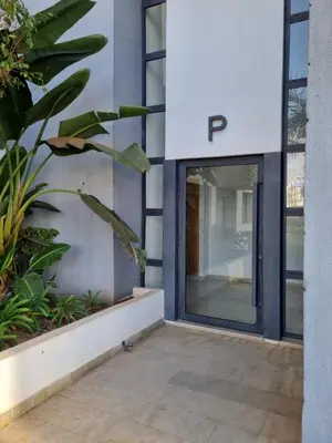 a glass door of a building with a letter p on it at Bel appartement à Harhoura in Oulad Kerroum