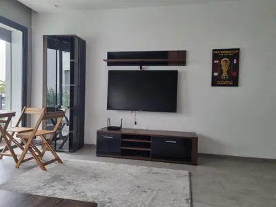 a living room with a flat screen tv on a wall at Bel appartement à Harhoura in Oulad Kerroum
