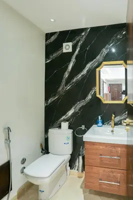 a bathroom with a white toilet and a sink at At Casablanca 's Home in Casablanca