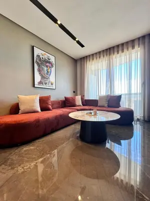 a living room with a couch and a table at CFC Luxury View Appt Anfa park in Casablanca