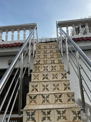 a set of stairs in front of a building at Villa Taroub avec piscine et vue sur mer in Temara