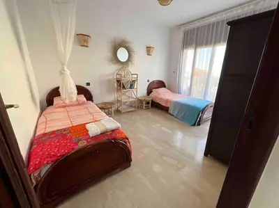 a bedroom with two beds and a mirror at Villa Taroub avec piscine et vue sur mer in Temara