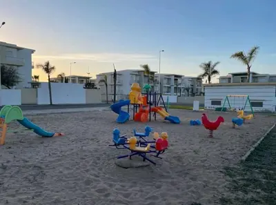 a playground with play equipment on the beach at Beach condo at Casabay plage Sidi Rahal in Casablanca