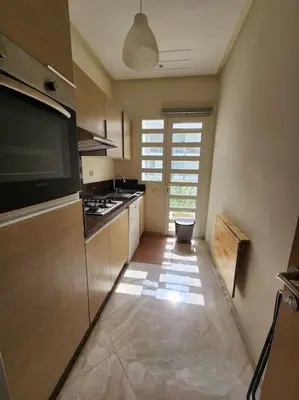 a kitchen with a stove and a counter top at Beach condo at Casabay plage Sidi Rahal in Casablanca