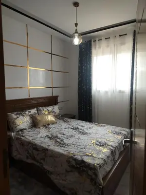 a bedroom with a bed and a window at Dahomey city in Bouznika