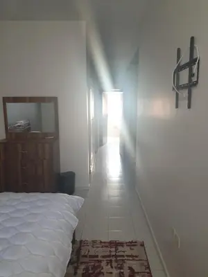 a bedroom with a white bed and a hallway at إقامة الياسمين in Rabat