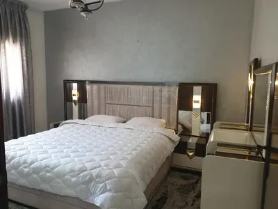 a bedroom with a large white bed with two pillows at إقامة الياسمين in Rabat