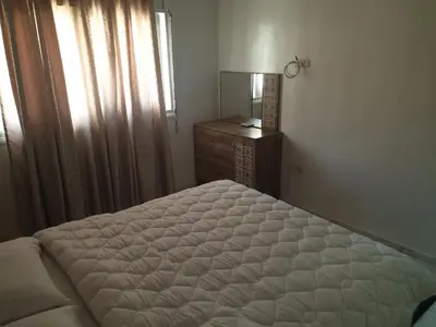 a bedroom with a bed and a dresser and a mirror at إقامة الياسمين in Rabat