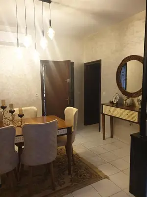 a dining room with a table and a mirror at إقامة الياسمين in Rabat