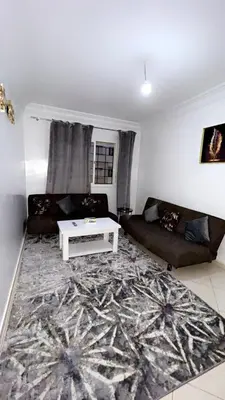 a living room with a couch and a table at Zen and cosy Appart Rose Marie Kasbah in Skhirat