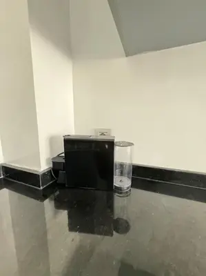 a microwave and a glass sitting on a floor at Front of beach apartment marina yakht 2 in Casablanca