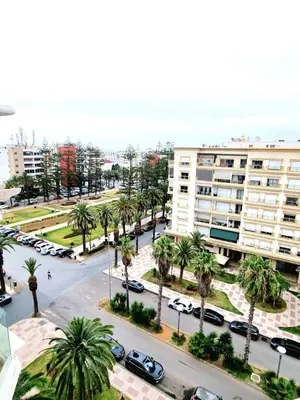 an aerial view of a street with palm trees and buildings at Appartement spacieux au cœur du Parc Proche plage Entre Casa et Rabat in Mohammedia