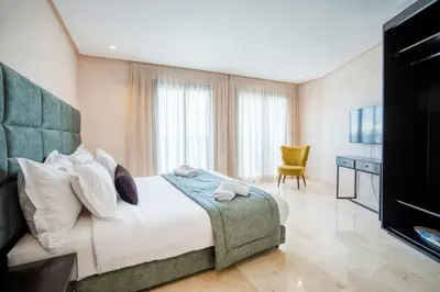 a hotel room with a bed and a television at AS Premium By Soho Hotels Maarif in Casablanca