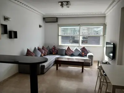 a living room with a couch and a window at Boulevard Anfa in Casablanca