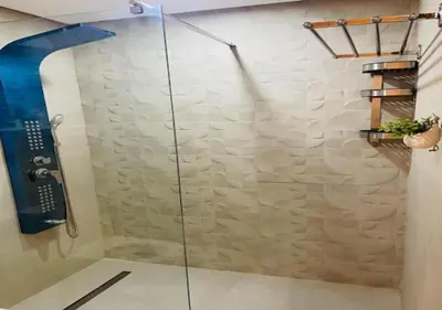 a shower with a glass door in a bathroom at Bel Appartement Cosy dans le centre de Casablanca in Casablanca