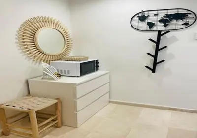 a mirror sitting on top of a dresser in a room at Bel Appartement Cosy dans le centre de Casablanca in Casablanca