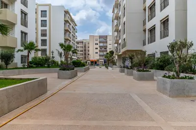 an empty sidewalk in a city with buildings at AeroStudio in Nouaceur